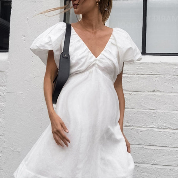 Beaumama robe mi-longue grossesse nœud papillon blanche